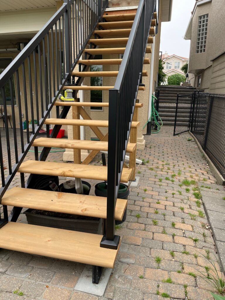 New wooden staircase with black metal railings built by Dandy RenoWork